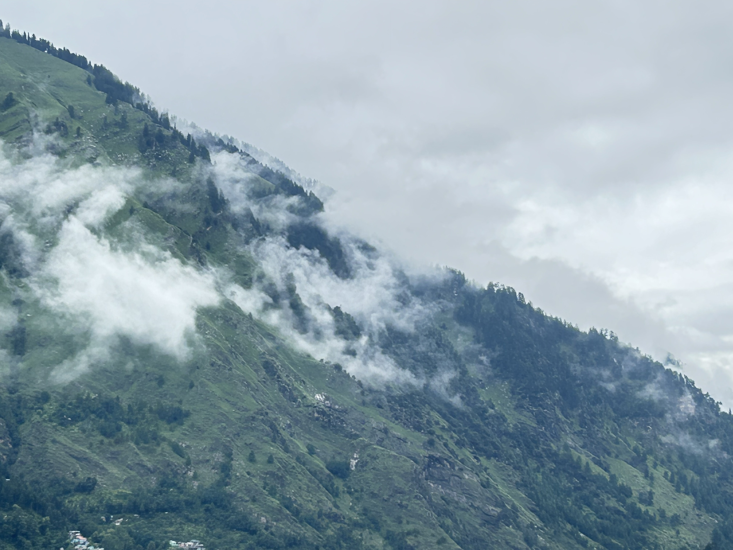 Mountain ridge above Manali wrapped in monsoon clouds